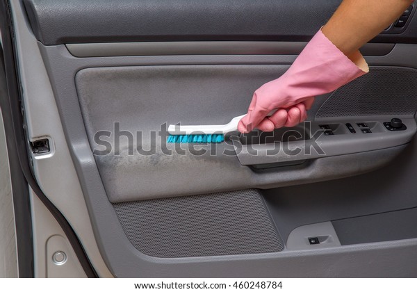  Car interior\
dirty textile door cleaning with professionally brush. Early spring\
cleaning or regular clean up.