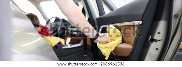Car interior and door handles cleaning. Car wash\
services concept