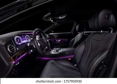 Car interior from driver seat view. Black leather cockpit with violet ambient light. - Shutterstock ID 1757903930