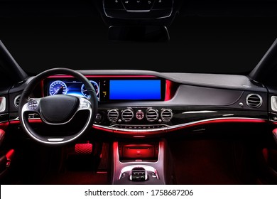 Car Interior From Driver Seat View. Black Leather Cockpit With Red Ambient Light.