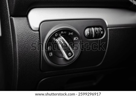 Car interior headlight buttons close up 