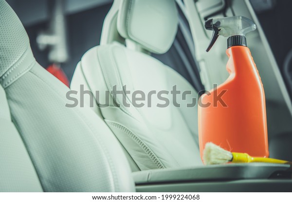 Car Interior Leather Cleaning\
Detergent in Orange Bottle. Vehicle Maintenance\
Theme.