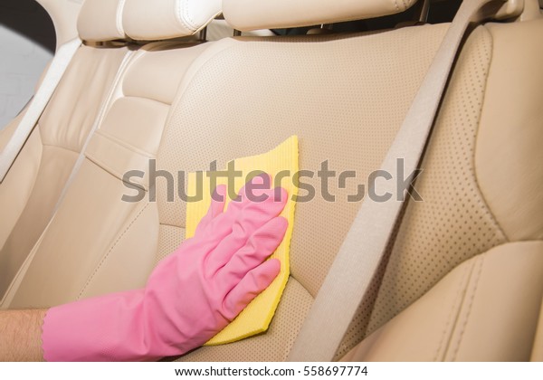 Car interior\
leather seats professionally chemical cleaning with cloth. Early\
spring cleaning or regular clean\
up.