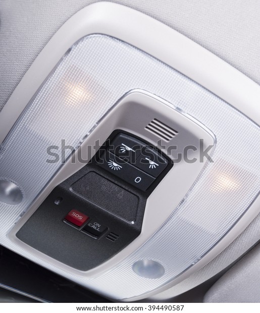 Car\
interior light panel on the top with buttons and\
lamp