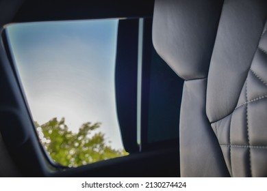 Car Interior Low Angle Shot Of Open Sunroof.