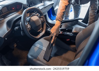 Car interior luxury service. Details of car cleaning male using professional steam vacuum for dirty car interior. - Powered by Shutterstock