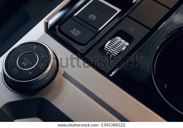 Car\
interior. Modern car illuminated dashboard. Luxurious car\
instrument cluster. Close up shot of automobile instrument panel.\
Modern car interior dashboard and steering\
wheel