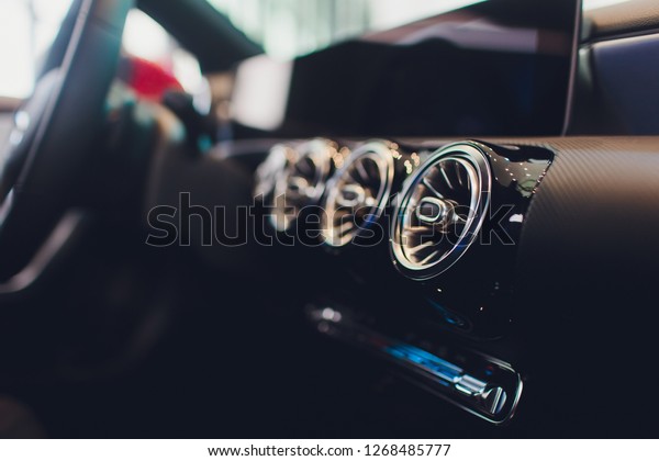car interior. Modern car speedometer\
and illuminated dashboard. Luxurious car instrument cluster. Close\
up shot of hybrid car instrument\
panel.