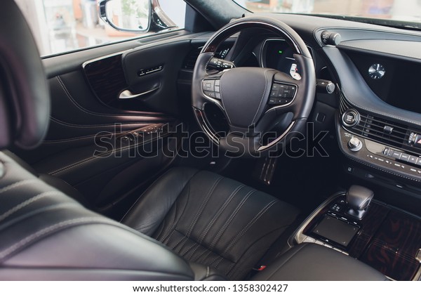 car interior. Modern car speedometer and\
illuminated dashboard. Luxurious car instrument cluster. Close up\
shot of car instrument\
panel.