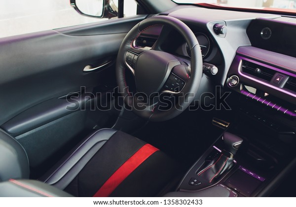 car interior. Modern car speedometer and\
illuminated dashboard. Luxurious car instrument cluster. Close up\
shot of car instrument\
panel.