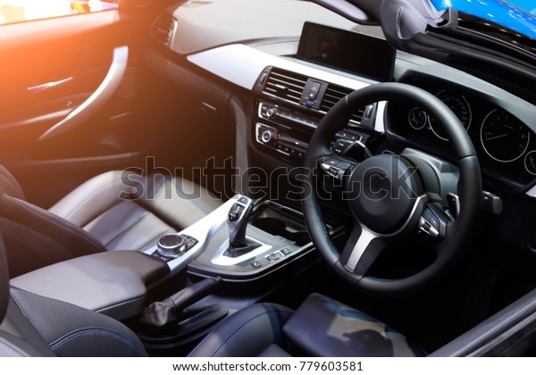 car interior. Modern car speedometer and\
illuminated dashboard. Luxurious car instrument cluster. Close up\
shot of hybrid car instrument\
panel