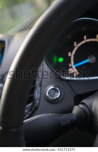 Car interior with turn signal switch (selective focus on\
signal switch) 