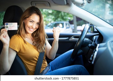 Car interior view of woman with driving license. Driving school. Young beautiful woman successfully passed driving school test. Female smiling and holding driver's license. - Shutterstock ID 1777875851