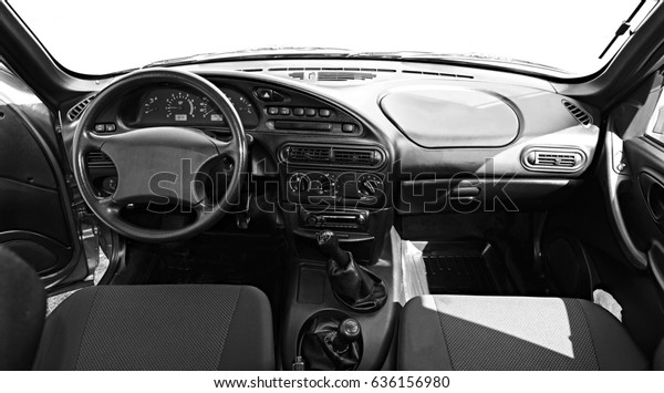Car interior-with dashboard, clock, media system,\
front seats and shift gear.