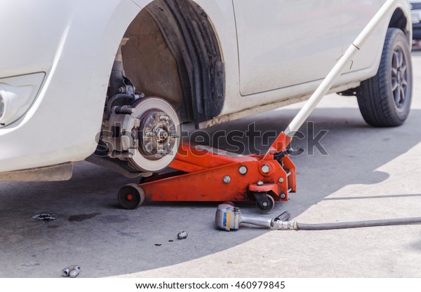 Car jack to lifting the car for replace wheel and\
repair at garage