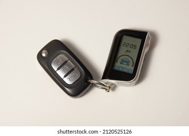 Car Key And Alarm Keychain On A White Background.