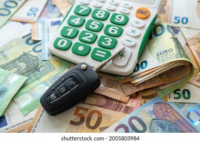 Car Key With Calculator On A European Money, Sale Or Rent Concept