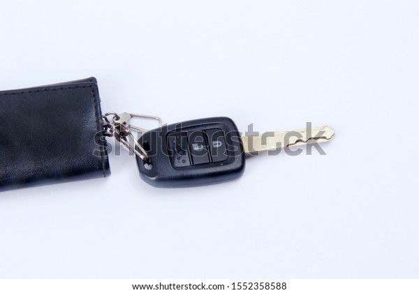 a car key with an electric button opens and closes\
the car door.