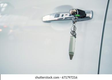 Car key inserted in lock of new modern car