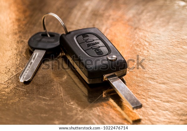 car key isolated on gold.\
close up