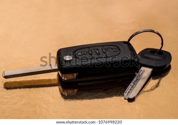 car key isolated on gold.
close up