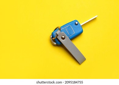 Car Key With Leather Keychain On Color Background