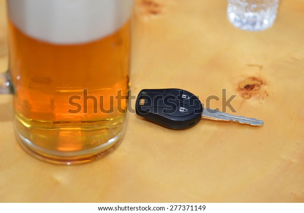car key\
lies on a table near the glasses of\
alcohol