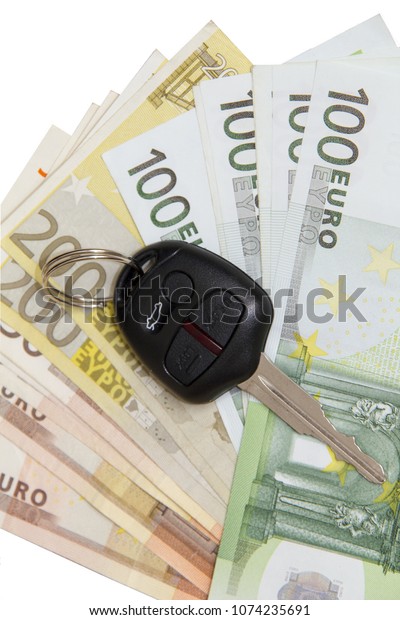 Car key on Euro money background isolated on white\
background.Concept photo of money, banking ,currency and foreign\
exchange rates.