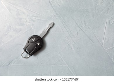 Car key on grey background, top view. Space for text