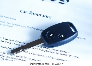 Car Key On An Insurance Policy. Toned.