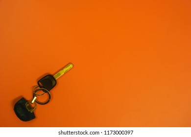 A car key on orange background, minimalist style image - Shutterstock ID 1173000397