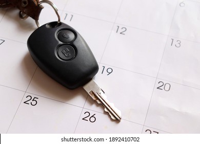 Car Key On Top Of Calendar. Holiday Travel And Car Loan Payment Concept. 