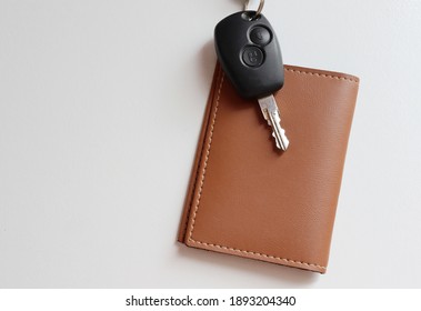 Car Key On Top Of Wallet. Car Payment Concept.