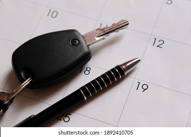 Car Key And Pen On Top Of Calendar. Car Payment Concept. 