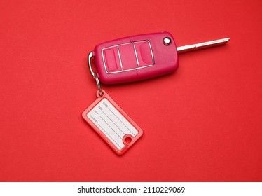 Car Key With Plastic Tag On Color Background