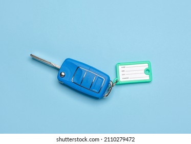 Car Key With Plastic Tag On Color Background