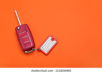 Car Key With Plastic Tag On Orange Background