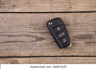 Car key with remote alarm control on the wooden desk