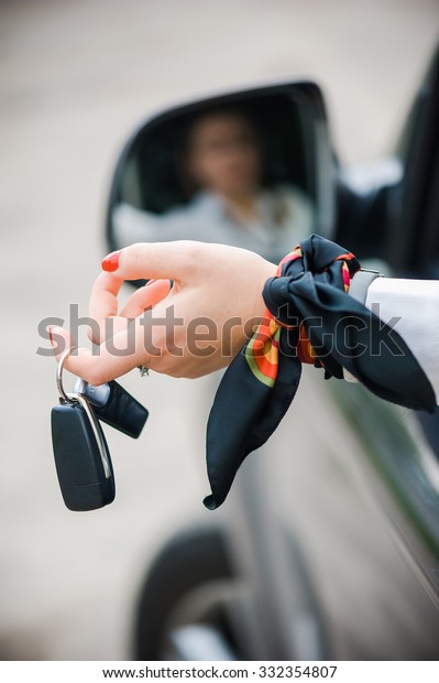 Car Key. Seller woman\
hand giving key