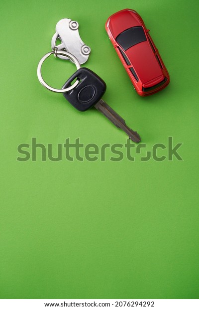 car\
key with silver model car on green background    \
