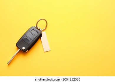 Car Key With Stylish Keychain On Color Background