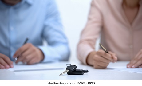 Car keys closeup, couple signing divorce documents about property division - Shutterstock ID 1539651920