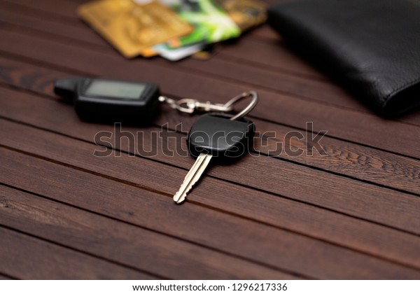 Car keys with\
credit cards on brown wood\
table
