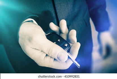 Car Keys Delivery. Dealership Salesman With Brand New Car Keys. Car Selling Concept.