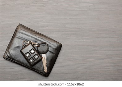 car keys and documents on dark wooden background