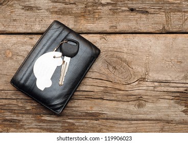 car keys and documents on dark wooden background