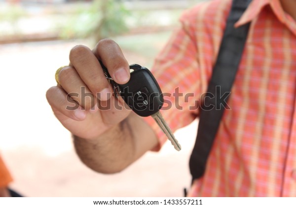 Car keys in hand, handing over to your loved\
ones For driving with\
confidence