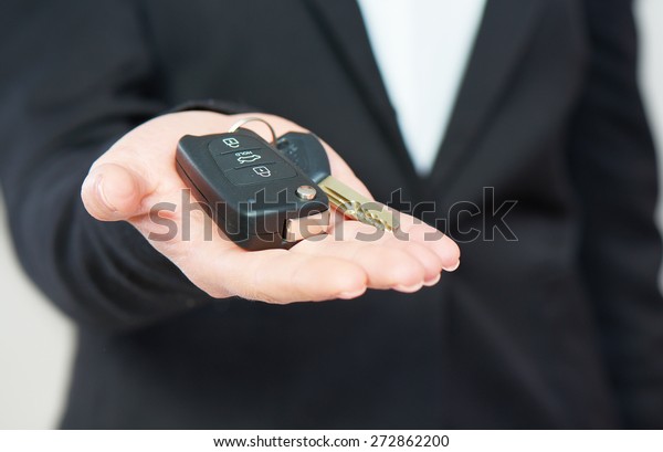 the car keys in hand men\
businessman