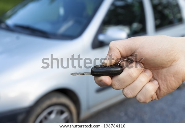 Car keys in hand to unlock\
door