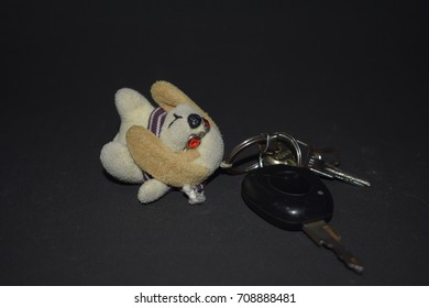 Car Keys Have A Dog Keyring On Black Background